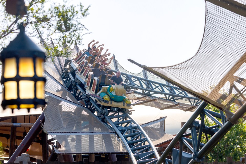 People enjoying a roller coaster ride at Universal's Epic Universe theme park.