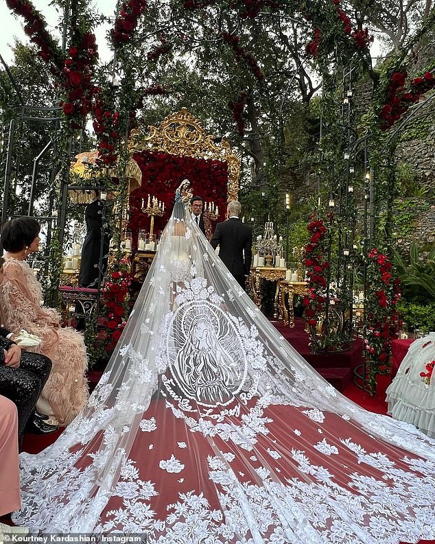 Kourtney Kardashian had her cathedral-length veil hand-embroidered with floral details and a huge image of the Virgin Mary inspired by a tattoo on her husband Travis Barker's head