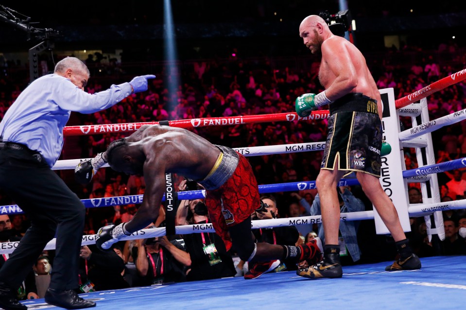 Tyson Fury knocking out Deontay Wilder in a boxing match.