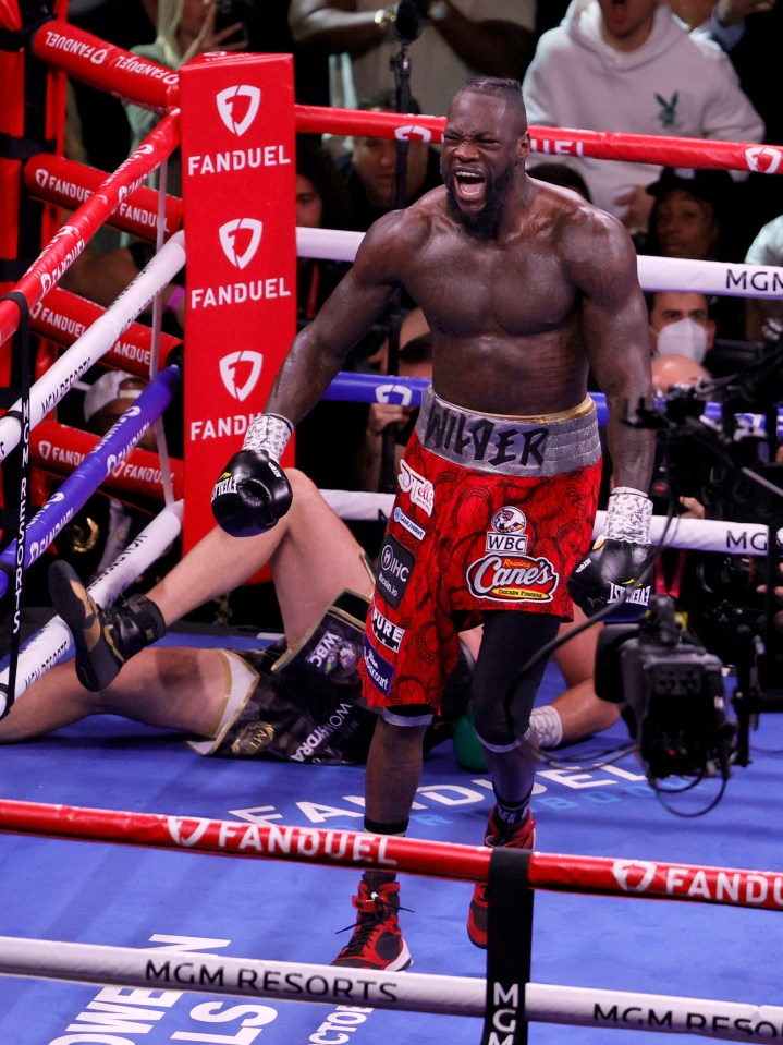 Deontay Wilder reacting after knocking down Tyson Fury in a boxing match.