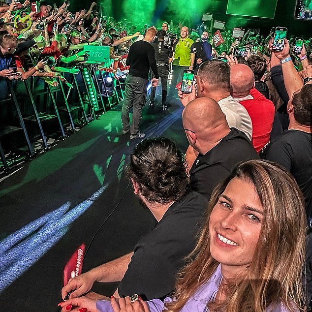Daphne, pictured showing her support for Van Gerwen at a tournament