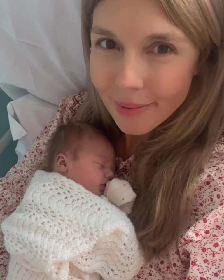 Woman holding a newborn baby.