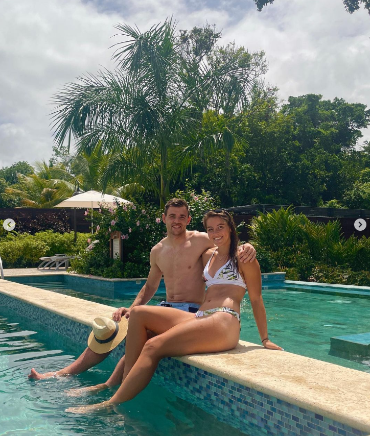 Couple relaxing by a resort pool.