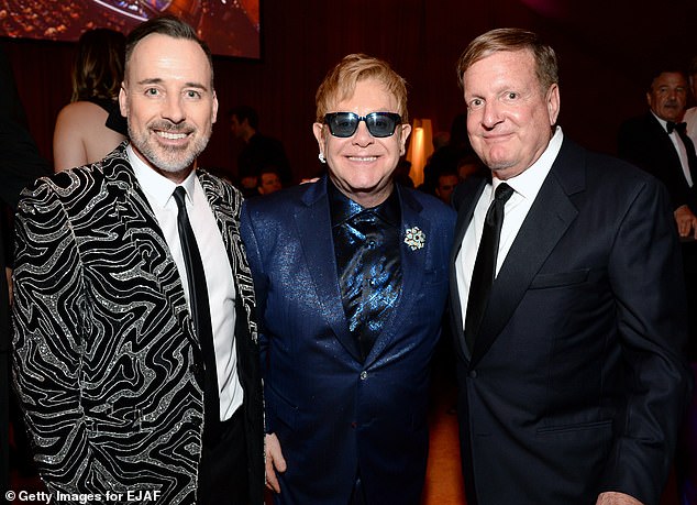 Ron Burkle is one of the ordinarily low-profile American real estate magnates who is eyeing the Cotswolds for his next project, which locals have slammed as a 'McMansion'. (Pictured: Burkle with Sir Elton John and David Furnish at a glitzy Hollywood event in 2016)