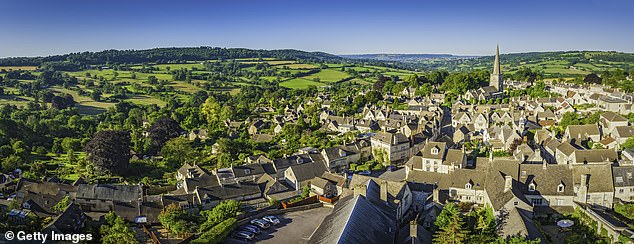 Pictured: vibrant green patchwork fields above the iconic Cotswold village of Painswick