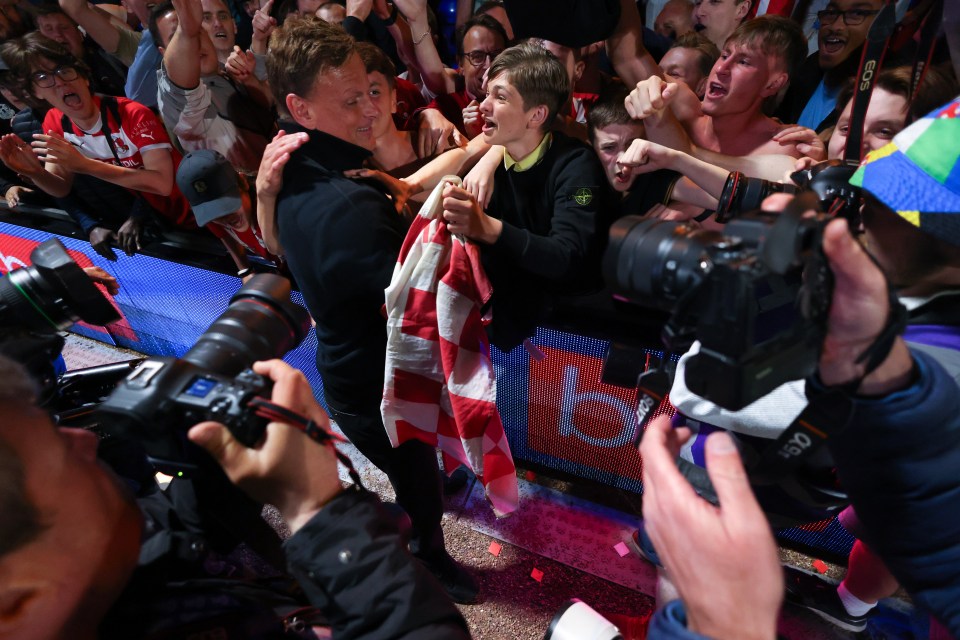 Richie Wellens, Leyton Orient's head coach, celebrating with fans after a penalty shootout win.