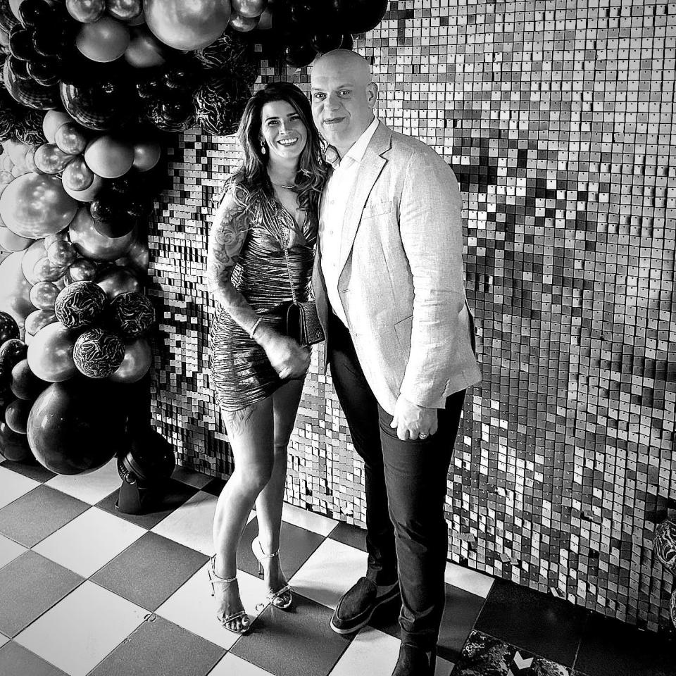 Black and white photo of a couple posing together.