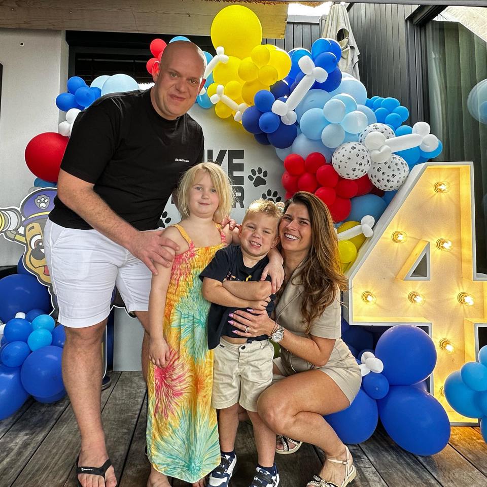 Family portrait at a child's 4th birthday party.
