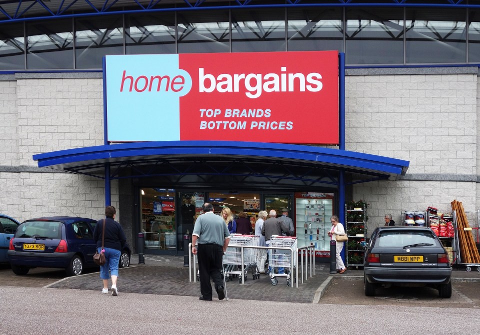 Home Bargains discount store entrance with customers and shopping carts.