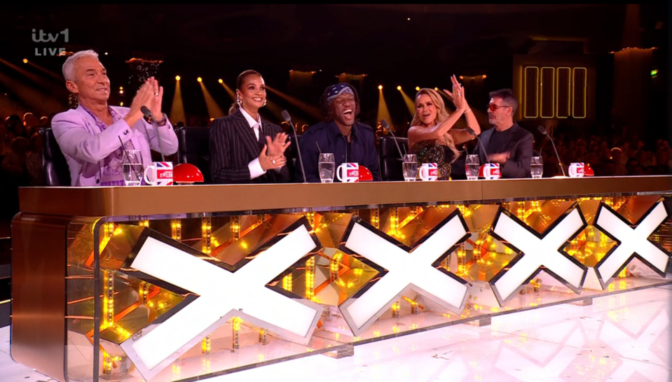 The X Factor judges at the judges' table.