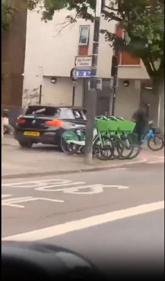 A street brawl breaks out as a driver runs over a cyclist.