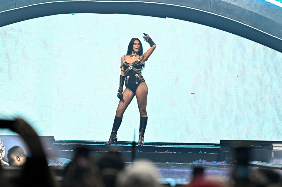 Dua Lipa performing on stage.