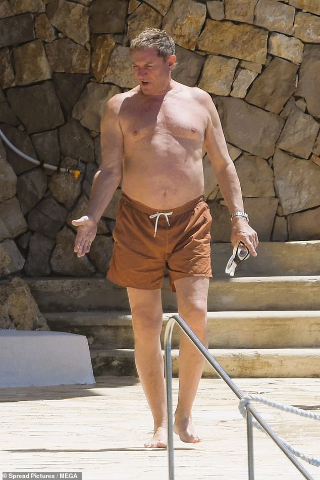 Simon went shirtless in a pair of brown swim shorts and goggles as he enjoyed the sunny outing