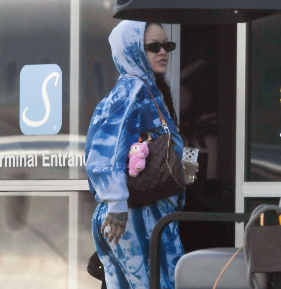 Rihanna and A$AP Rocky arriving at a terminal in a golf cart.