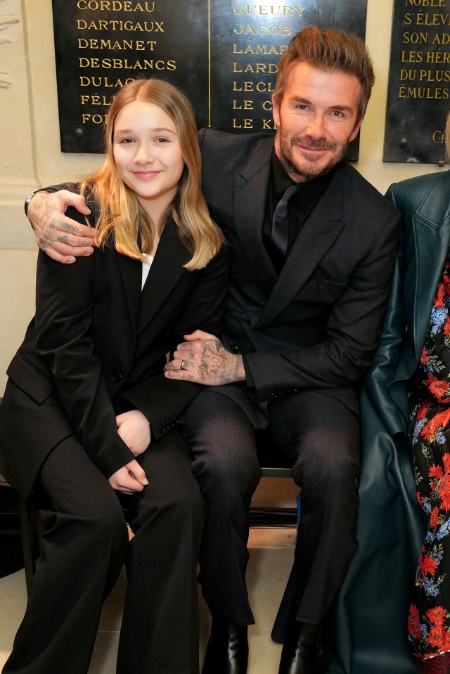 Harper and David Beckham at a fashion show.
