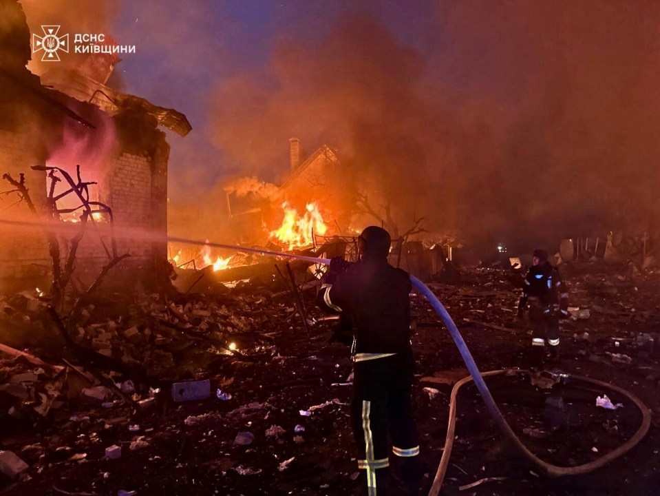 Firefighters battling a fire at a building in the Kyiv region of Ukraine.