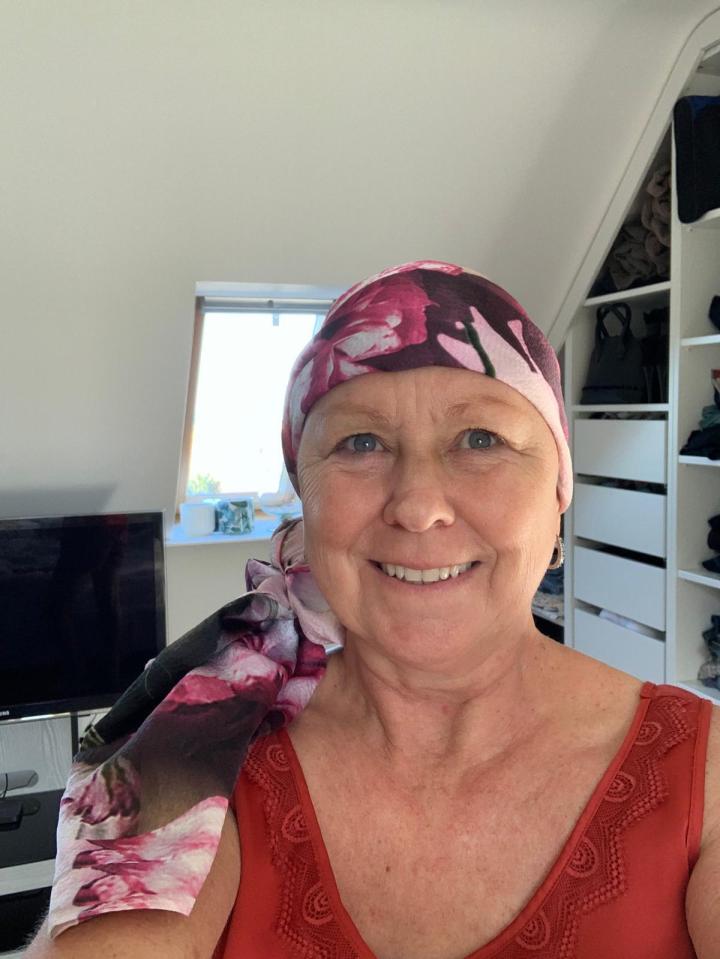 Woman wearing a floral headscarf.