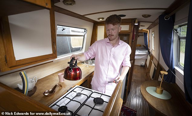 A man in a fetching pink shirt busies himself with the furnace with a few expert touches
