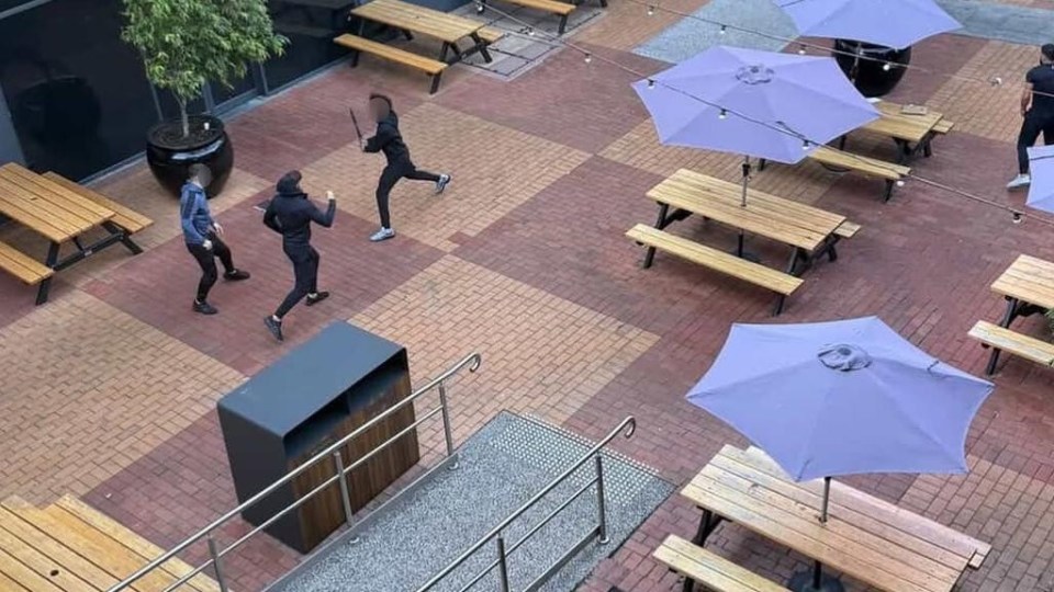 Overhead view of a Melbourne shopping center in lockdown, showing several people fighting with weapons.