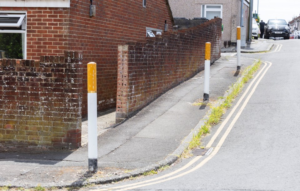 Bollards painted as cigarettes on a residential street.
