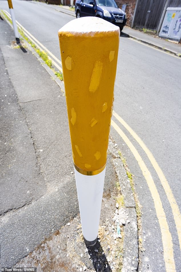 The bollards have been painted to look like giant cigarettes, with a very realistic design