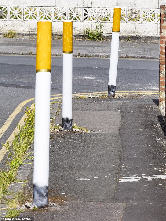 Bollards painted to look like cigarettes have been spotted on the street - with some locals calling it 'disgusting'