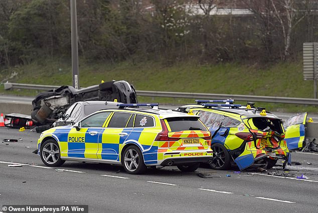 Debris from the destroyed police cars was strewn all over the width of the carriageway (pictured)