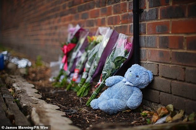 Floral tributes and a blue teddy bear has been placed up against a brick near near to where the fire took place -- May 25, 2025