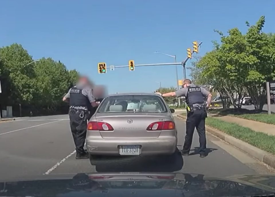 Police officers conducting a traffic stop.
