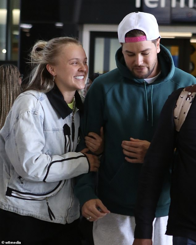 The pair, who recently spent her birthday week enjoying a romantic mini-break in Orlando, appeared to be in high spirits as they made their way across the airport with their luggage