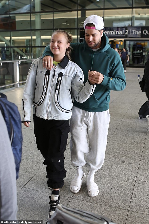 He sweetly held her hand and put his arm around her shoulder