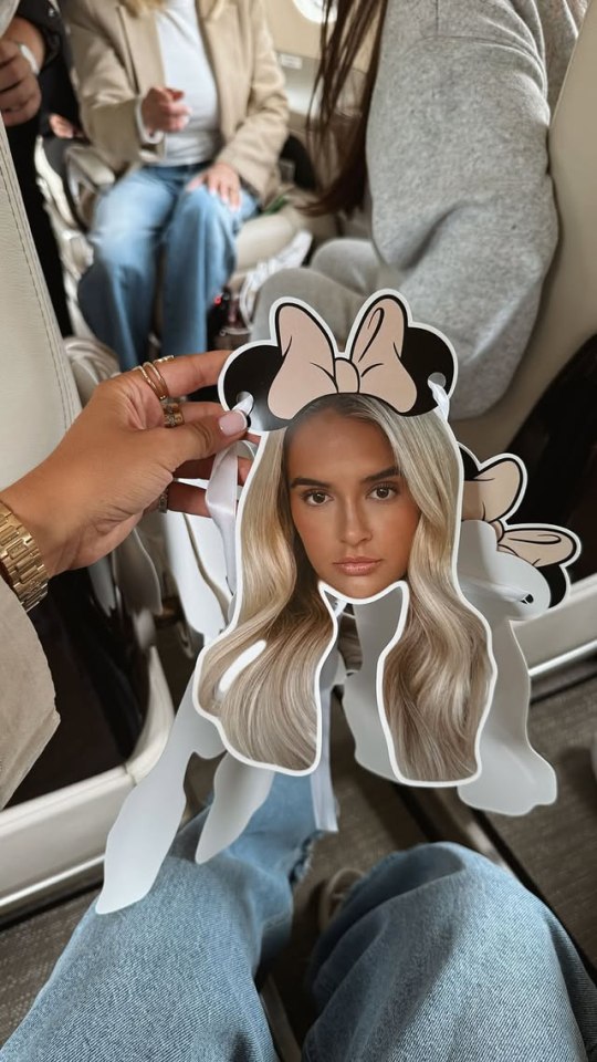 Minnie Mouse ears with a woman's face on a private jet.