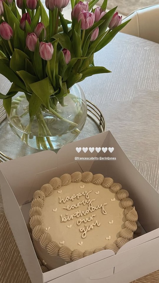 Birthday cake with tulips in the background.