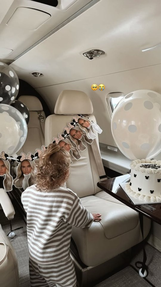 Toddler on private jet with birthday decorations.