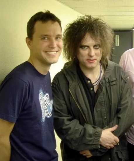 Photo of Robert Smith with members of Blink-182.