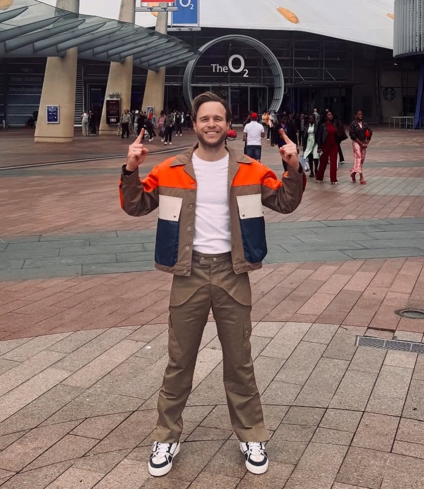 Olly Murs posing outside The O2 arena.