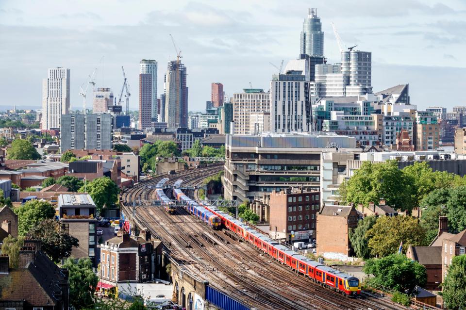 Aerial view of London's South Bank, showing trains on railway tracks and a cityscape with modern and older buildings.