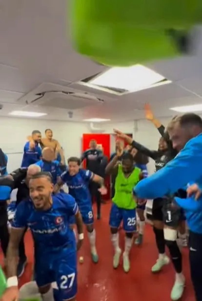 Soccer players celebrating in a locker room.