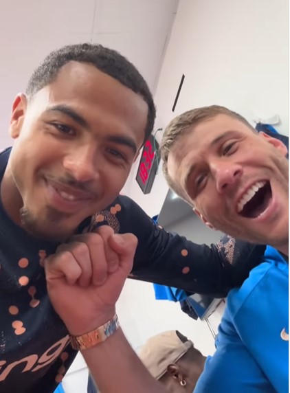 Two men smiling and bumping fists.