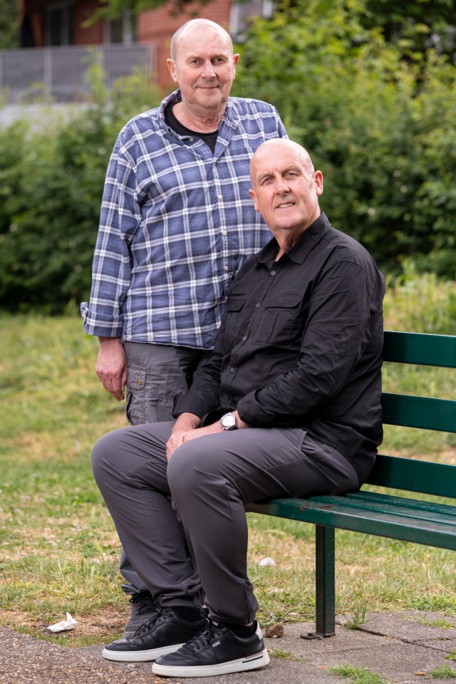 Two men sitting on a park bench.
