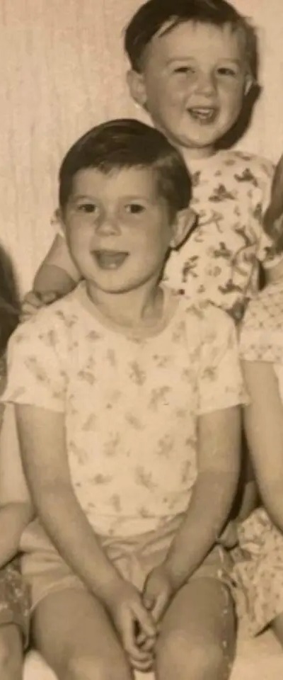 Black and white photo of five young children, two boys and three girls.