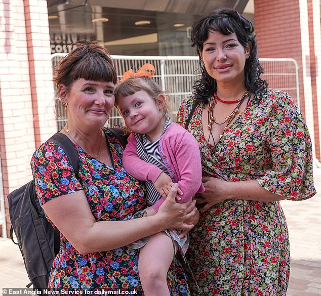 Lydia Walters, 37, (left) and her daughter Daisy, three, with Anna Pont, 36, outside the former Debenhams store that is still empty in the centre of Ipswich, Suffolk