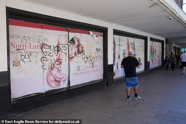 Peeling beauty product posters were defaced with graffiti outside the Debenhams store in the centre of Norwich, Norfolk