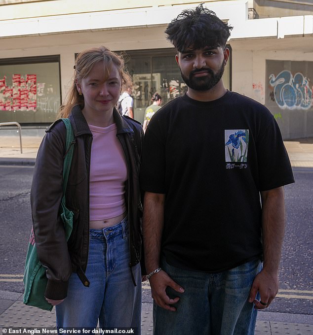 UEA student Sukhman Kunner, 20, said: 'They could use the space for something else. It's an eyesore being covered in all those Communist posters.' Pictured: Mr Kunner with his friend Aimee Hurry, 20, a UEA graphics student