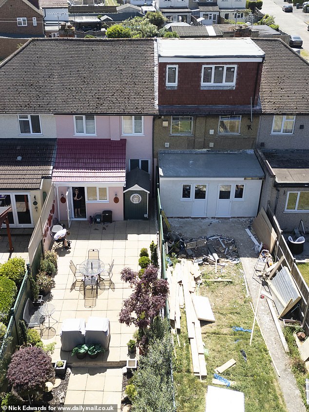 Roger and Gail's pink house has a well kept garden and patio, in comparison with the house of multiple occupancy (HMO) being built next door