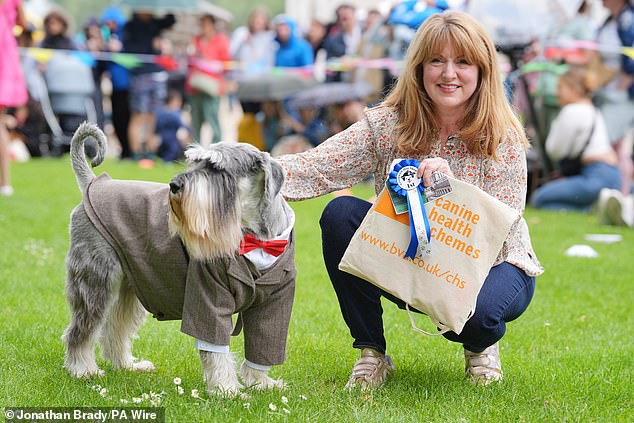 Giant schnauzer Mr Darbyshire took the first place crown in the 'Best Dressed Pooch competition. Pictured with her proud owner Tara Veitch, her four-legged companion adorned a suit