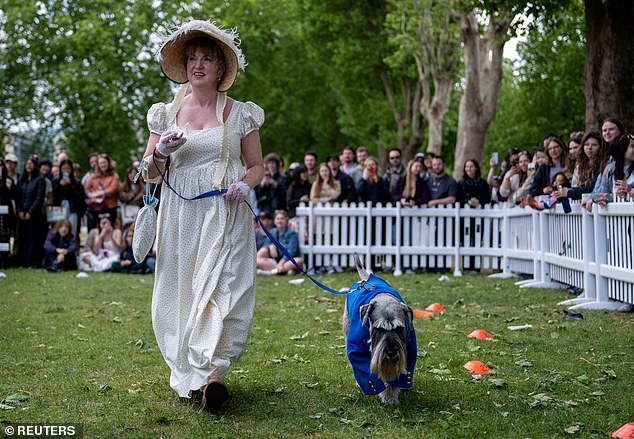 Schnauzer Mr Darby pictured with his proud owner while competing in the Best Bridgerton Lookalike competition - a nod to the Old Royal Naval College site which featured in the famous Netflix series