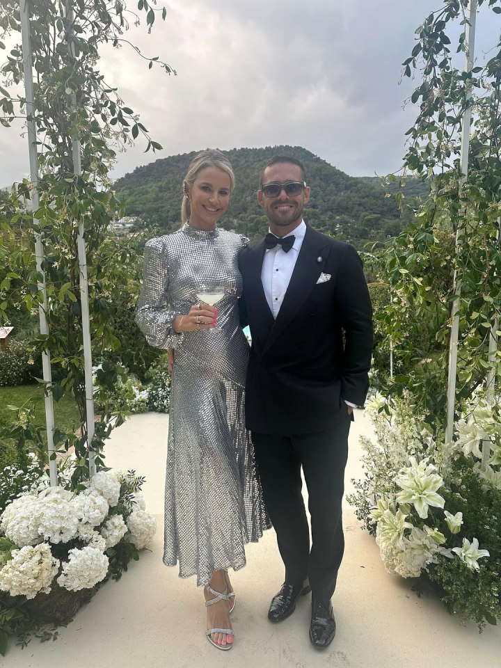 Couple in formal wedding attire posing together.
