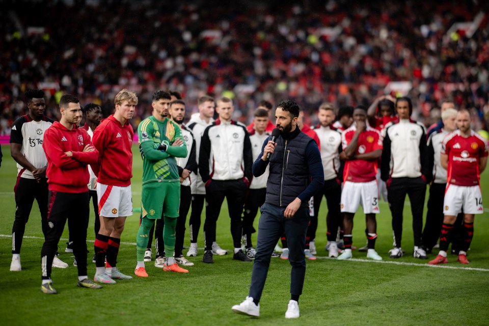 Manchester United manager addressing players on the field.