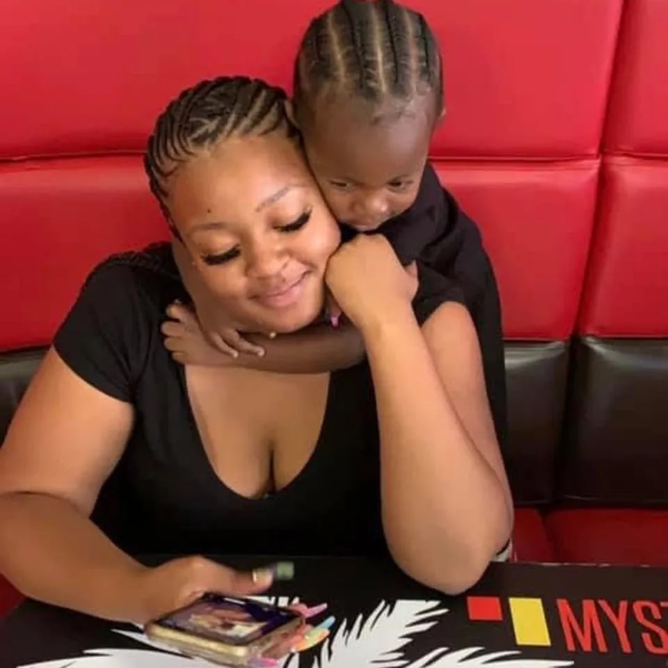 Woman embracing her child.